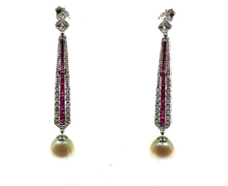 A pair of white gold earrings mounted with ruby, diamonds and  pearl. aloy 585/000 l. 6 cm.Witgouden oorhangers bezet met rob