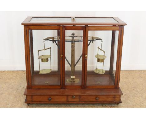 Brass scale, big size, in glass mahogany chest, with 2 doors, in  the bottom 3 drawers, by: Dechet, h. 68 w. 82,5 d. 43 cm.Me