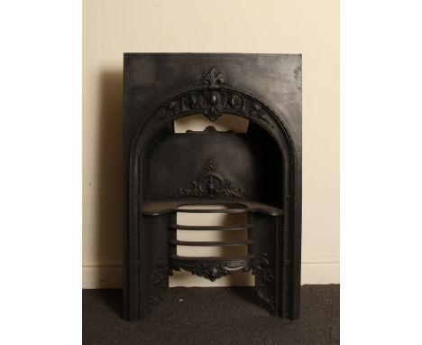 Early Victorian cast iron fire insert with decorative arch and raised grate