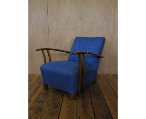 Art Deco electric blue upholstered deep cushioned armchair with beech wood frame.