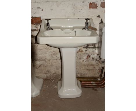 Art Deco style porcelain wash basin with simple chrome taps