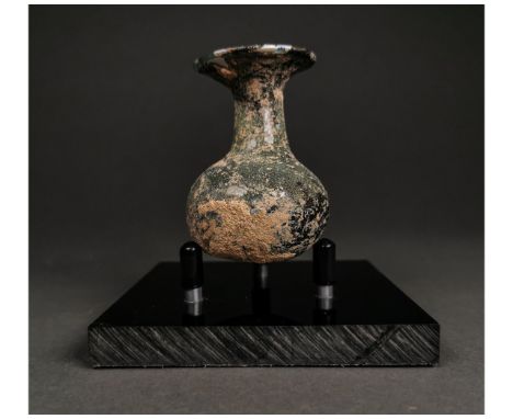 Ca.200-400 AD. A light green glass squat bulbous body jar, short neck, flared wide mouth. Intact. A nice example.beautiful ir