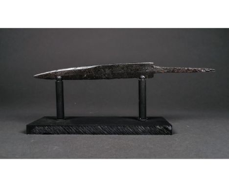 Ca.600-800 AD. A substantial single-edged scale-tang iron dagger with shallow tip. Good condition; on a custom stand; 250mm; 