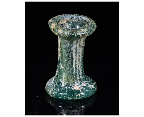 Ca.100 AD. A Romano-Egyptian ‘Cotton Reel’ unguentarium in cast, mottled, teal-colored glass. The flask has a wide everted fl