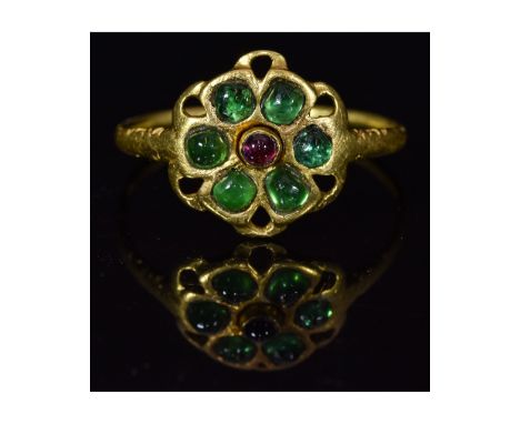 Ca.1400 AD. Wearable (British or French) Medieval gold ring consisting of an open-work floral shaped bezel with green emerald