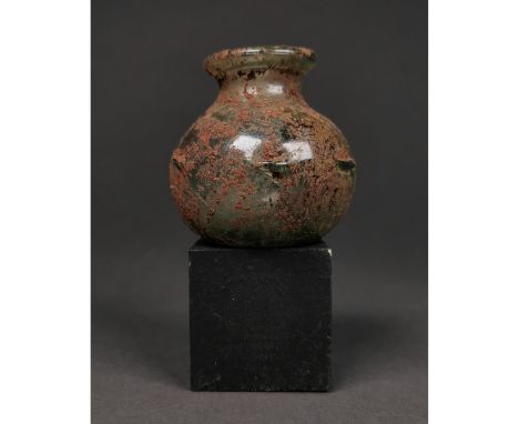 Ca.200-400 AD. A light green glass squat bulbous body jar having a crimped decoration at mid-body. Intact. A nice example. it