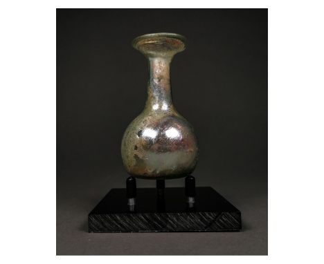 Ca.100-300 AD. A Roman flask made from pale blue glass. It features a large, bulbous body, a long, thin neck, and wide mouth.