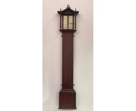 A Regency rosewood cased stick barometer, the moulded arched top with three brass urn finals over turned pilasters, straight 