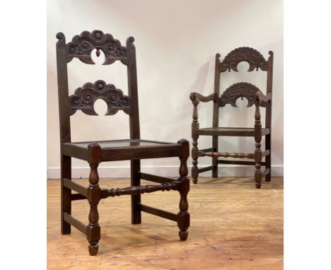 A set of six (4+2) oak Derbyshire chairs of 17th century design, each with shaped, scrolled and floral carved double rail bac