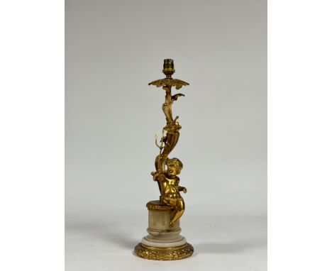 A Rococo Revival gilt-metal and alabaster table lamp, modelled with a putto holding a trident and resting on a fluted alabast