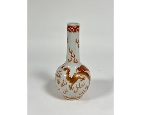 A Chinese iron red and gilt decorated porcelain vase, of flask form, painted with dragons and flaming pearls, with underglaze