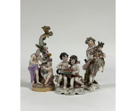 A group of 19th century Continental porcelain figures comprising: a Meissen figural candlestick (candle socket replaced, repa