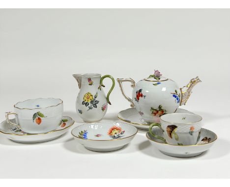 A Herend Vegetable pattern partial tea service comprising: teapot with floral knop; cream jug; teacup and saucer; coffee cup 