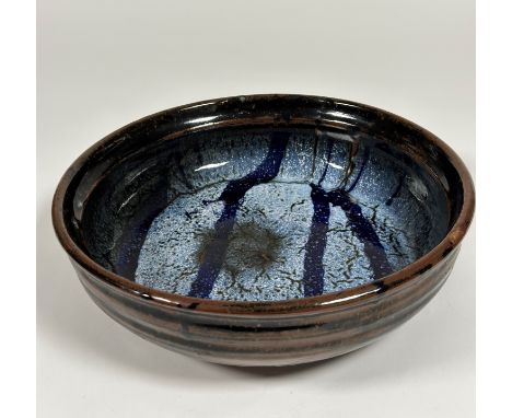 Trevor Corser (British, 1938-2015), for Leach Pottery, a large shallow stoneware bowl, the well in blue glazes, impressed per