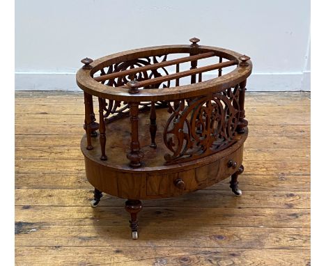 A Victorian figured walnut and rosewood two division music Canterbury of oval outline, with a spindle and fret gallery, havin