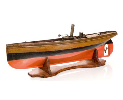 A LIVE STEAM POWERED MODEL LAUNCH, CIRCA 1910, the hull carved from the solid and painted pink below the waterline with black
