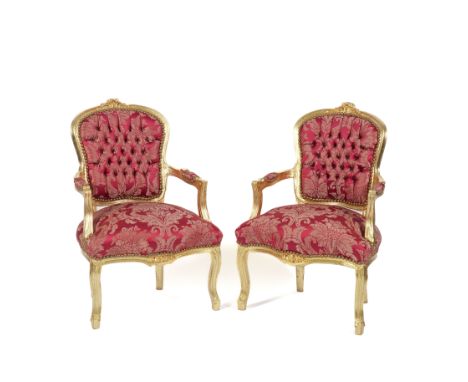 A PAIR OF GILT FRAMED OPEN ARMCHAIRS (2)With floral print button back scarlett upholstery, 63cm wide; 92cm high