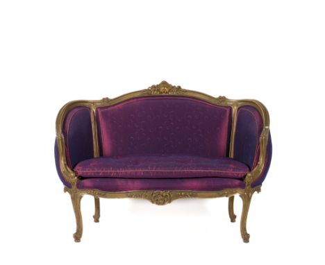A GILT FRAMED TUB BACK TWO SEAT SOFAWith cartouche and floral carved frame on scroll feet, 131cm wide; 94cm high