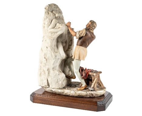 CAPODIMONTE; A FIGURE OF MICHELANGELO SCULPTINGOn stepped wooden base, 52cm high