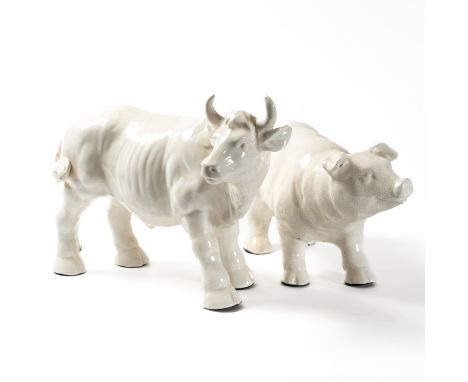 A WHITE GLAZED CERAMIC FIGURE OF A BULL (2)30cm high, together with a similar figure of a pig, 22cm high
