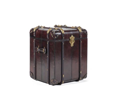 AN OCCASIONAL TABLE MODELLED AS A BRASS BOUND TRAVELLING TRUNKWith lift top, 50cm wide; 50cm deep; 60cm high