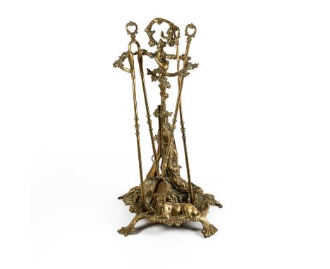A FRENCH CAST BRASS HUNTING THEMED THREE PIECE COMPANION SET AND STAND (5)The stand, 56cm high, together with a Rococo reviva