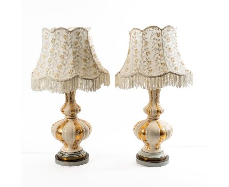 A PAIR OF PARCEL GILT AND CREAM CERAMIC BALUSTER TABLE LAMPS (2)With floral beaded shades, each 75cm high