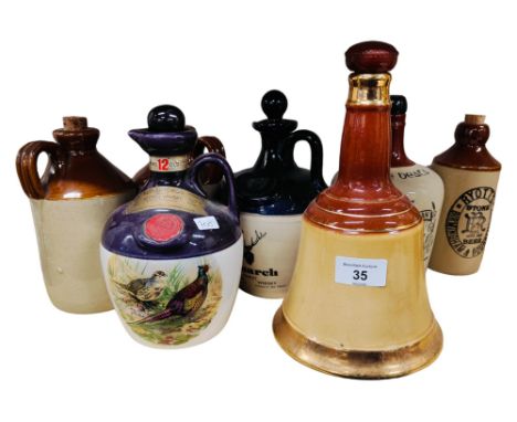 SHELF LOT OF WHISKEY DECANTERS AND STONEWARE 