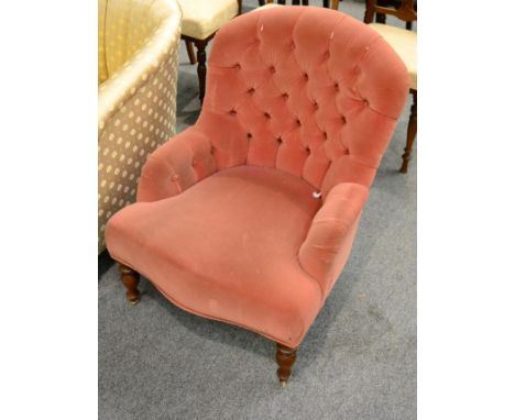 A pink button back nursing chair 