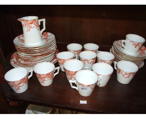 ORANGE AND WHITE CUPS, SAUCERS AND PLATES