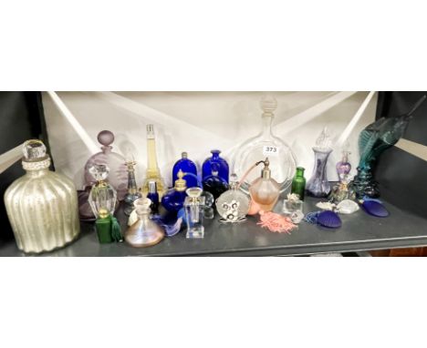 A collection of coloured glass perfume bottles including a blue glass perfume bottle marked R. Lalique to base.