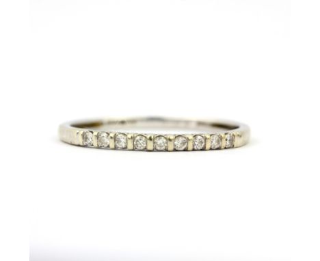 A 9ct white gold diamond set half eternity ring, (P.5). Approx 11g.