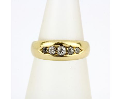 A hallmarked 18ct yellow gold ring set with graduated old cut diamonds, (M.5). Approx 4.5g.