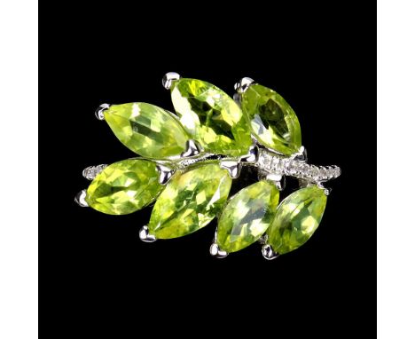 A 925 silver ring set with marquise cut peridots and white stones, (O).