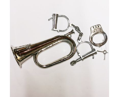 Two pairs of reproduction handcuffs and bugle.