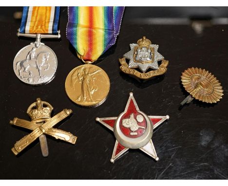 A WWI pair to 23125 PTE. H. ROFE E.SUR. R., together with an East Surrey Regiment cap badge, two other cap badges and a Galli