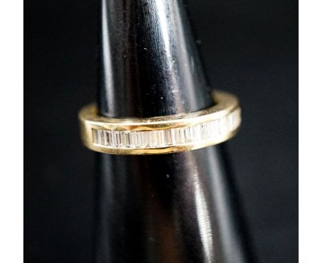 A continental 750 yellow metal and baguette cut diamond set half eternity ring, size L, gross 5.1 grams.