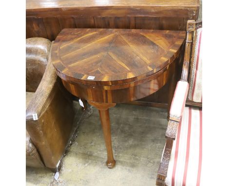A 18th century Continental Goncalo Alves demi-lune card table with folding top, width 84cm, depth 56cm, height 76cm