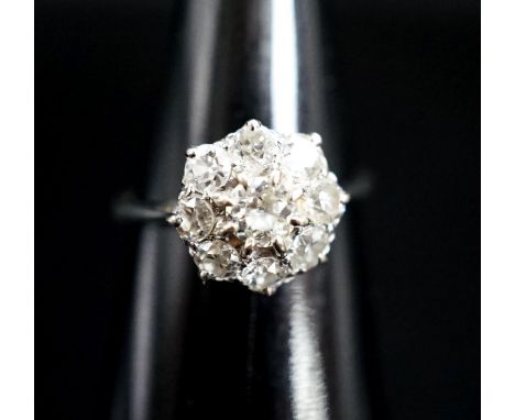 A white metal and diamond cluster ring, size J, gross 2 grams.