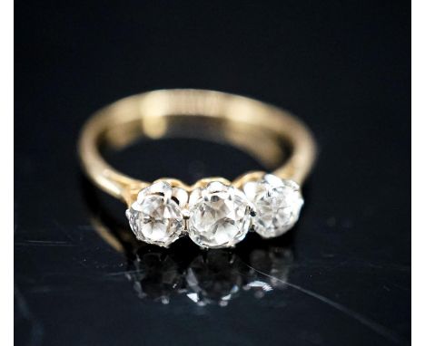A yellow metal and three stone diamond ring, size M, gross 1.9 grams.