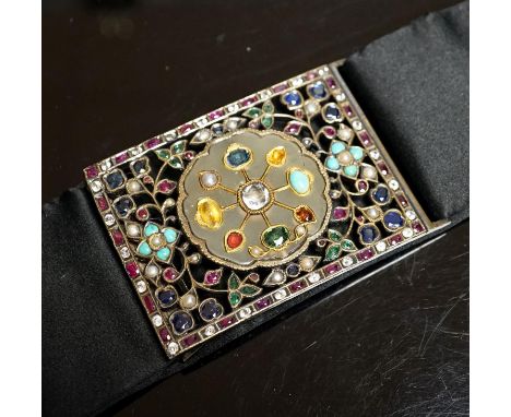 An Indian multi gem set belt buckle, mounted on a black sash belt, buckle 8cm.
