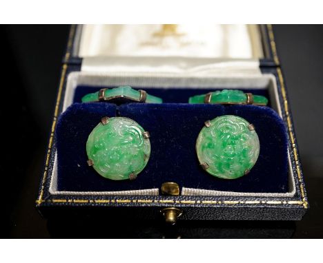 A pair of white metal mounted carved jade cufflinks, largest panel approx. 25mm.