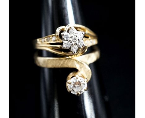 A modern 14k and solitaire diamond ring, size O/P and one other 14k and diamond cluster ring, gross 6.1 grams.