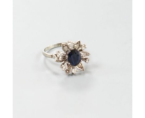 A 1930's 18ct white gold, sapphire and diamond cluster set flower head ring, size Q/R,gross weight 6 grams.