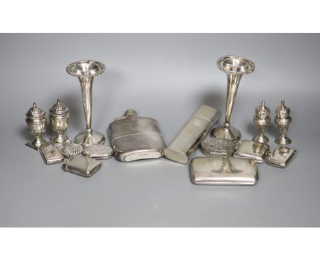 A group of assorted silver including two hip flasks, two spill vases, condiments, vesta cases, cigarette case, scent flask et