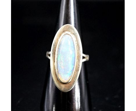 A 9ct white gold and oval cabochon white opal set dress ring,size M, gross weight 6.9 grams.