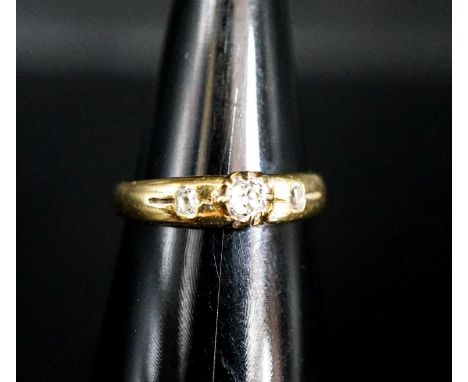 An 18ct and three stone claw and gypsy set diamond ring, size O/P, gross weight 4.2 grams.