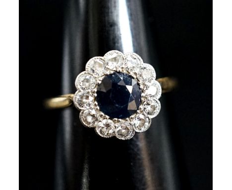 An 18ct, sapphire and diamond set circular cluster ring, size M, gross weight 2.4 grams.