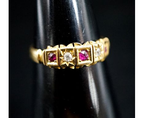 A late Victorian 18ct gold, ruby and diamond chip set half hoop ring, size O, gross 2.5 grams.