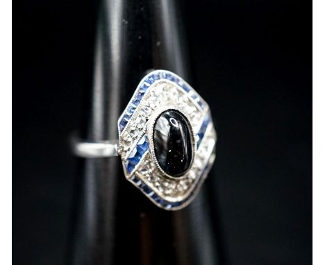 A 1920's white metal (stamped plat), sapphire and diamond ring, with central cabochon sapphire, size M, gross weight 4.6 gram